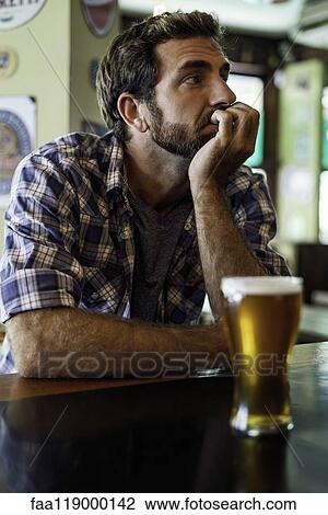 Man sitting in beer bar View Large Photo Image Stock Image - Man sitting in beer bar. Fotosearch