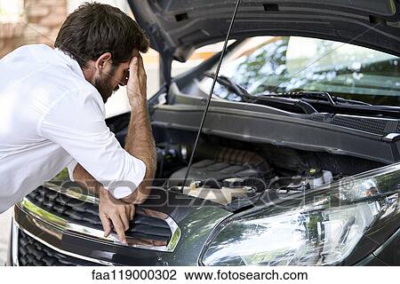Man standing by car View Large Photo Image Stock Image - Man standing by car. Fotosearch