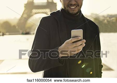 Man using smart phone View Large Photo Image Picture - Man using smart phone. Fotosearch