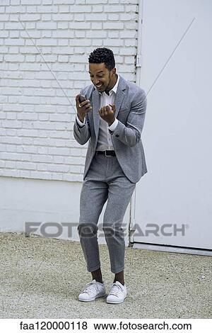 Man using smartphone outdoors View Large Photo Image Stock Photo - Man using smartphone outdoors. Fotosearch