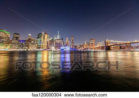 Manhattan skyline and Brooklyn Bridge at night View Large Photo Image Picture - Manhattan skyline and Brooklyn Bridge at night. Fotosearch
