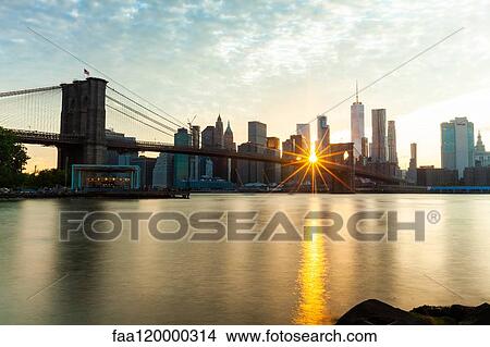 Manhattan skyline and Brooklyn Bridge at sunset View Large Photo Image Picture - Manhattan skyline and Brooklyn Bridge at sunset. Fotosearch