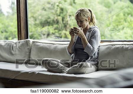 Mature woman having coffee at home View Large Photo Image Stock Image - Mature woman having coffee at home. Fotosearch