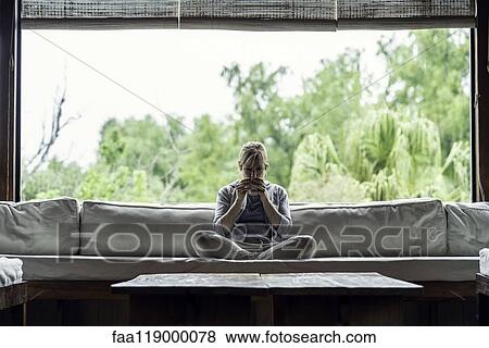 Stock Photo - Mature woman having coffee at home. Fotosearch