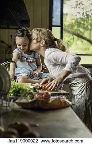 Stock Image - Mature woman kissing her granddaughter. Fotosearch