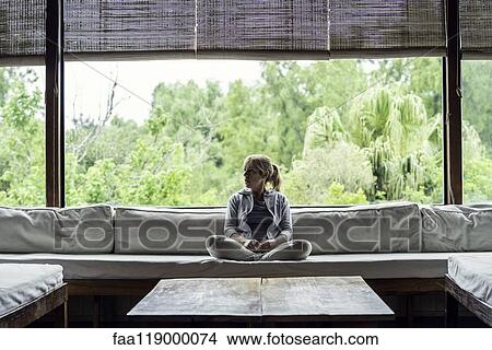 Mature woman sitting on sofa View Large Photo Image Picture - Mature woman sitting on sofa. Fotosearch