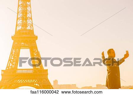 Mid adult man taking selfie View Large Photo Image Stock Image - Mid adult man taking selfie. Fotosearch