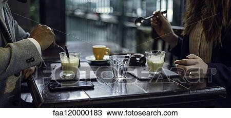 Mid section of couple eating dessert View Large Photo Image Stock Image - Mid section of couple eating dessert. Fotosearch