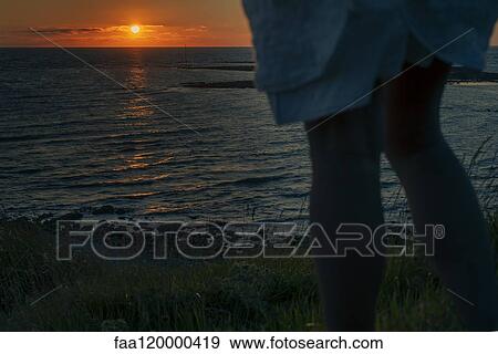 Midsection of woman standing by sea View Large Photo Image Stock Photo - Midsection of woman standing by sea. Fotosearch
