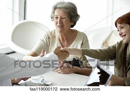 Mother and daughter greeting doctor in clinic View Large Photo Image Stock Image - Mother and daughter greeting doctor in clinic. Fotosearch
