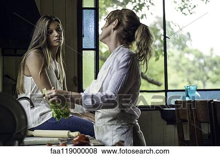 Stock Photo - Mother and daughter in kitchen. Fotosearch
