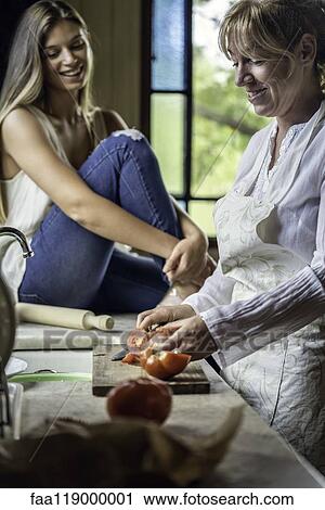 Mother and daughter preparing food in kitchen View Large Photo Image Stock Image - Mother and daughter preparing food in kitchen. Fotosearch