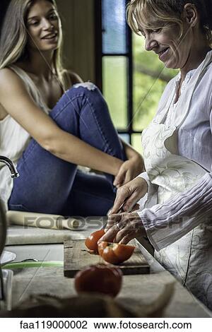 Mother and daughter preparing food in kitchen View Large Photo Image Stock Image - Mother and daughter preparing food in kitchen. Fotosearch