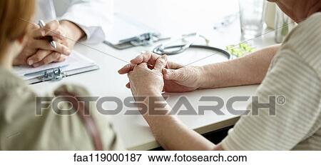 Mother and daughter sitting in clinic View Large Photo Image Stock Photo - Mother and daughter sitting in clinic. Fotosearch