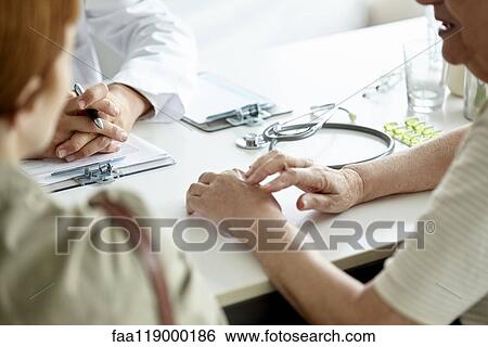 Mother and daughter talking with doctor View Large Photo Image Stock Photograph - Mother and daughter talking with doctor. Fotosearch