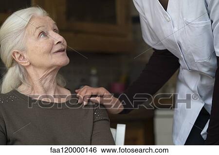 Nurse consoling woman View Large Photo Image Stock Photograph - Nurse consoling woman. Fotosearch
