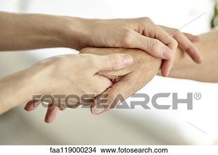 Nurse holding patient's hand View Large Photo Image Picture - Nurse holding patient's hand. Fotosearch