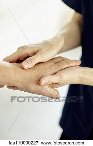 Nurse holding patient's hand View Large Photo Image Stock Photo - Nurse holding patient's hand. Fotosearch