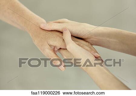 Stock Photograph - Nurse holding patient's hand. Fotosearch