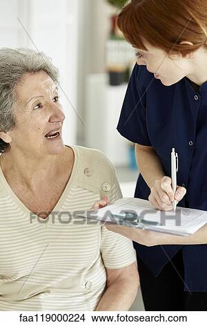 Nurse writing medical history of patient View Large Photo Image Picture - Nurse writing medical history of patient. Fotosearch