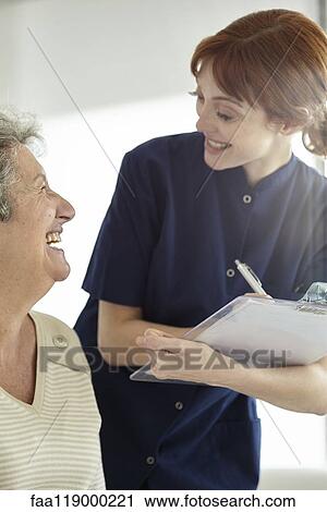 Nurse writing medical history of patient View Large Photo Image Stock Image - Nurse writing medical history of patient. Fotosearch
