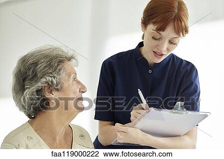 Nurse writing medical history of patient View Large Photo Image Stock Image - Nurse writing medical history of patient. Fotosearch