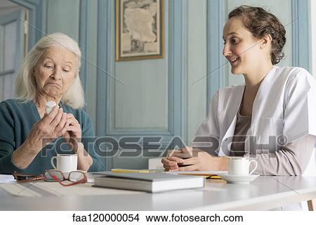 Patient looking at pill bottle View Large Photo Image Picture - Patient looking at pill bottle. Fotosearch