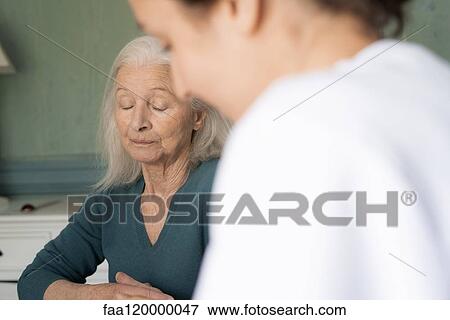 Patient sitting with doctor View Large Photo Image Stock Photo - Patient sitting with doctor. Fotosearch