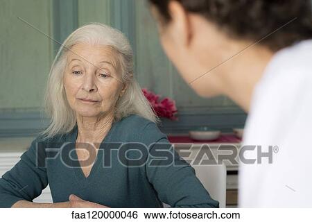 Patient sitting with doctor View Large Photo Image Stock Photograph - Patient sitting with doctor. Fotosearch