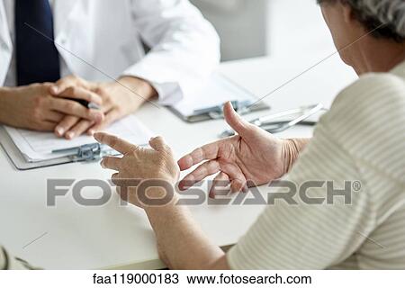 Stock Image - Patient talking with doctor. Fotosearch