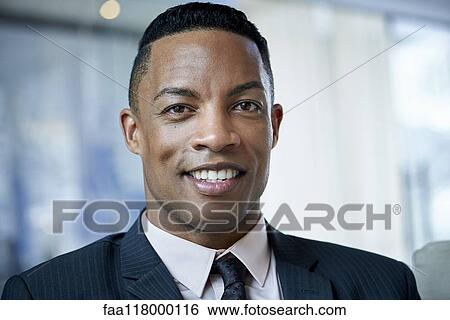 Stock Photograph - Portrait of businessman in office. Fotosearch