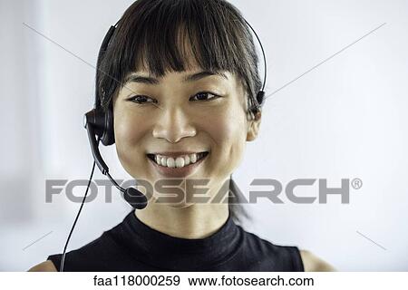 Portrait of businesswoman wearing headset View Large Photo Image Stock Photo - Portrait of businesswoman wearing headset. Fotosearch