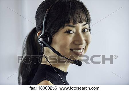 Portrait of businesswoman wearing headset View Large Photo Image Stock Photograph - Portrait of businesswoman wearing headset. Fotosearch