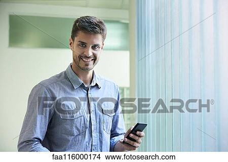 Portrait of engineer standing in office View Large Photo Image Picture - Portrait of engineer standing in office. Fotosearch