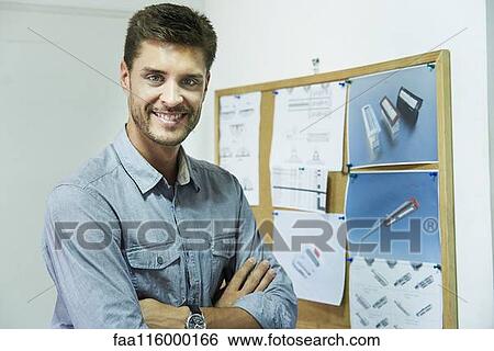 Portrait of engineer standing in office View Large Photo Image Stock Photograph - Portrait of engineer standing in office. Fotosearch