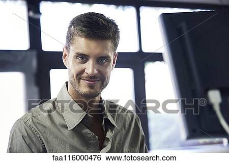 Portrait of engineer standing in office View Large Photo Image Stock Photograph - Portrait of engineer standing in office. Fotosearch
