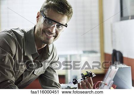 Portrait of engineer working in office View Large Photo Image Stock Image - Portrait of engineer working in office. Fotosearch