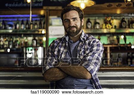 Portrait of man leaning against bar counter View Large Photo Image Stock Image - Portrait of man leaning against bar counter. Fotosearch