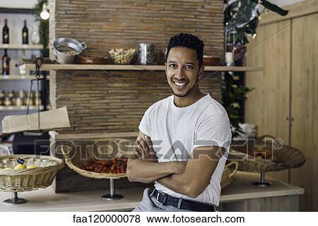 Portrait of man sitting in shop View Large Photo Image Stock Photo - Portrait of man sitting in shop. Fotosearch
