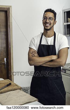 Portrait of man standing in commercial kitchen View Large Photo Image Stock Image - Portrait of man standing in commercial kitchen. Fotosearch