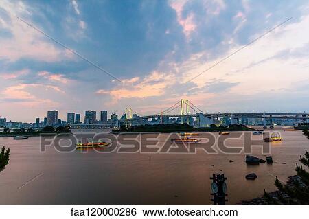 Rainbow bridge with Tokyo skyline at dusk View Large Photo Image Stock Photograph - Rainbow bridge with Tokyo skyline at dusk. Fotosearch