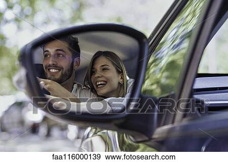 Reflection of couple in wing mirror View Large Photo Image Stock Photo - Reflection of couple in wing mirror. Fotosearch