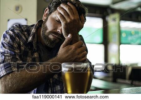 Sad man sitting in bar View Large Photo Image Stock Image - Sad man sitting in bar. Fotosearch