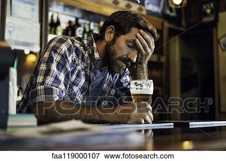 Sad man sitting in beer bar View Large Photo Image Stock Photo - Sad man sitting in beer bar. Fotosearch