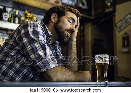 Sad man sitting in beer bar View Large Photo Image Stock Photography - Sad man sitting in beer bar. Fotosearch