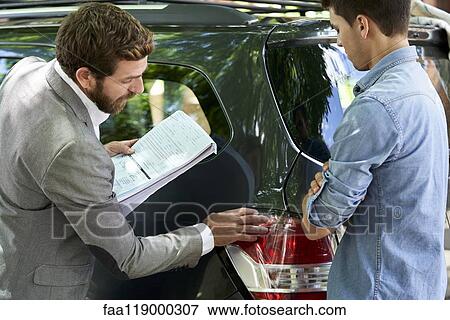 Stock Photo - Salesman assisting customer. Fotosearch