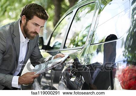 Salesman examining car View Large Photo Image Stock Image - Salesman examining car. Fotosearch