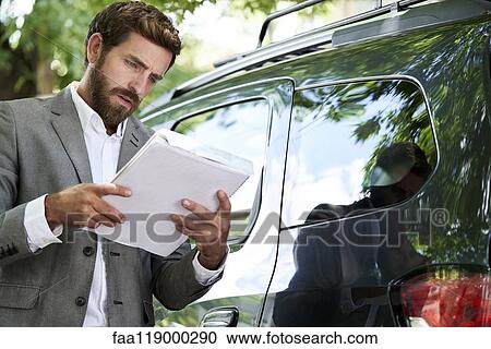 Salesman reading documents View Large Photo Image Stock Image - Salesman reading documents. Fotosearch