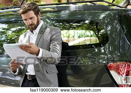 Salesman reading documents View Large Photo Image Stock Photo - Salesman reading documents. Fotosearch