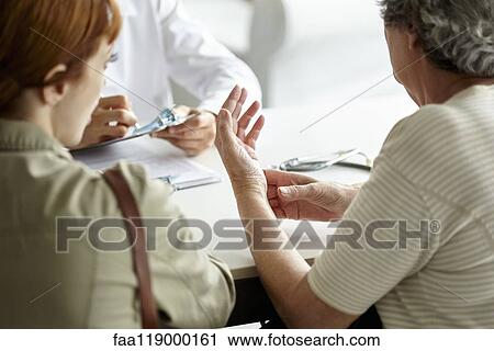 Stock Image - Senior patient talking with doctor. Fotosearch